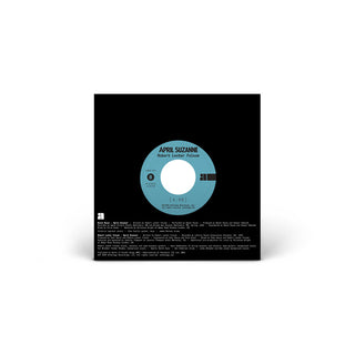 A vinyl record sleeve or album cover shown from the back, featuring a black background with a circular light blue label in the center reading 'APRIL SUZANNE' and 'Robert Luddie Fiction.'.