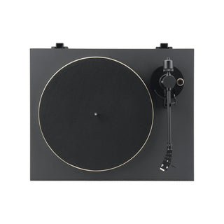 A top-down view of a black turntable with a gold-colored outer ring around the platter, featuring a black tonearm on the right side, set against a solid white background.