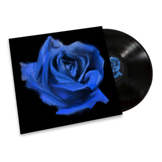 A vinyl record partially pulled from its sleeve, showing a large painted blue rose on a black cover against a white background.