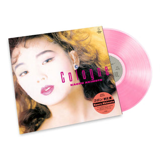 A vinyl record partially pulled from its sleeve on a white background. The album cover features a close-up portrait of a woman with wavy hair, and the record itself is translucent pink.