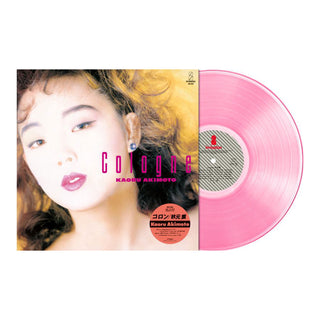 A pink vinyl record partially pulled from its sleeve, featuring a close-up portrait of Kaoru Akihojo on the cover with the title 'Colours' and Japanese text.