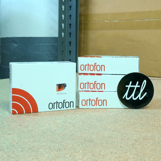 ortofon boxes and a ttl logo sticker on a surface