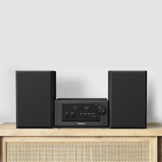Black audio system with two speakers on a wooden cabinet against a light gray background Panasonic
SC-PM700PP-K Stereo System (CD Player, Bluetooth, FM Radio