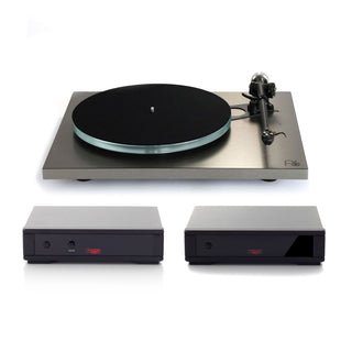 A turntable with a brushed silver metal plinth, black platter, and tonearm, shown above two matching rectangular electronic devices on a clean white background.