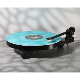 Rega: Replay Turntable playing a blue vinyl record
