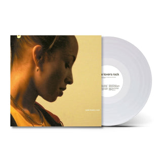 A vinyl record album shown with its sleeve partially covering the disc. The sleeve features a warm-toned portrait of a woman in profile against a pale yellow background, and the record itself is translucent white.