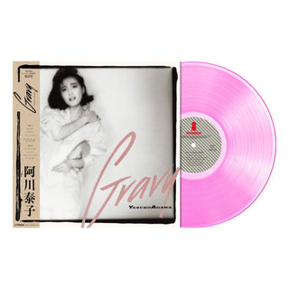 A vinyl record album shown with its sleeve and the record partially pulled out. The sleeve features a black-and-white portrait of Yasuko Agawa with a tan side panel and large pink script text.